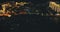 Night illuminated cityscape at sea bay aerial. Cars at traffic bridge road. City downtown buildings