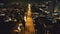 Night illuminated cityscape with traffic highway at business centre aerial. Twilight city neon light