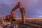 Night image of a hydraulic hammer in the works of expansion of a road