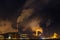 night industrial landscape environmental pollution waste of thermal power plant. Big pipes of chemical industry enterprise plant