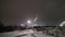 Night industrial landscape. View of a large plant and snow-covered territory. Cold winter weather. Severe polar climate