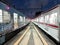 night at the Jakarta Kota station, two electric trains passing in the corridor of the station, the commuter line