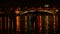 Night lake in the city center with beautiful bright reflections. The boat floats.