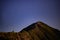 Night landscape with an alpine refuge and starry sky seen from rocky mountains