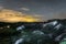 Night landscape with chalk ridges under cloudy and starry sky