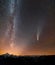 Night landscape of mountains with stars covered Milky Way sky and Neowise comet with light tail