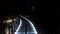 Night lighted metal elevated bridge in city park