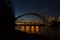 Night lights - harbor bridge, river, water reflection and evening sky