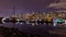 A night long exposure photo of many yachts and boats docked inside a marinamarina