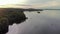 Night Northern seascape on lake Onega-waves beat on the forest shore, the water reflects the sky