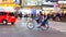 Night panning photography of unidentified woman with a child riding bicycle at Shibuya Square.The