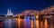 Night panorama of the illuminated Hohenzollern bridge over Rhine river. Beautiful cityscape of Cologne, Germany