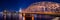 Night panorama of the illuminated Hohenzollern bridge over Rhine river. Beautiful cityscape of Cologne, Germany