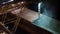 Night panorama of loading grain crops on bulk freighter ship via trunk to open cargo holds at silo terminal in seaport