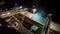 Night panorama of loading grain crops on bulk freighter ship via trunk to open cargo holds at silo terminal in seaport