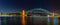 Night panorama Sydney Harbor Bridge with reflections in the sea.