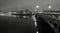 Night panorama view over river to old stony bridge between historical parts of town