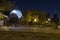 Night park landscape with well and glowing lanterns.