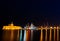 Night photo of ancient fortress and pier in Rhodes city on Rhodes island, Dodecanese, Greece. Stone walls and bright night lights