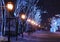 Night photo of the central city street in the snow with old lanterns decorated with Christmas New Year lights