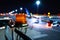 Night photo, close-up, yellow beacon to attract attention to the large-sized airport equipment. Blurred aircraft parking