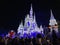 Night photo Magic Kingdom Disney Castle draped with holiday lights