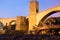 Night photo of Medieval bridge with city gate. Besalu, Catalonia