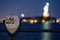 Night photo optical binoculars to view the Statue of Liberty blurry in the background