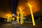 Night photography of artwork `Aspire` trees sculpture gleams bright and gold under the concrete of freeway at Ultimo NSW.