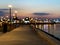 night pink sunset at pier lantern blurred light on horizon port of Tallinn Baltic bike near bench on promenade Estonia