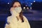 Night portrait of a woman in a face mask, concept of problems with the coronavirus quarantine