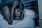 Night portrait of young sad and worried black african American woman in bed at home sleepless and stressed feeling depressed suffe
