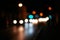 Night road city blur bokeh shot. Blurred street with carlights in night time. Defocused urban scene. Toned shot