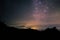 Night scape with beautiful colorful milky way and yellow sunset light. Space background. stary sky at the mountain. I