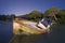 Night scene of an abandoned and sunken fishing boat on the coast of Cadiz, Spain