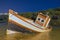 Night scene of an abandoned and sunken fishing boat on the coast of Cadiz, Spain