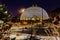 Night scene of the Desert Dome, with the moon barely visible on the side, at Henry Doorly Zoo Omaha Nebraska.