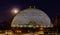Night scene of the Desert Dome, with the moon riding on the side, at Henry Doorly Zoo Omaha Nebraska.