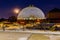 Night scene of the Desert Dome, with the moon riding on the side, at Henry Doorly Zoo Omaha Nebraska.