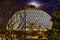 Night scene of the Desert Dome with the moon riding on top at Henry Doorly Zoo Omaha Nebraska.