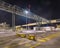 Night scene with illuminated petrochemical production plant and massive pipeline overpass, Antwerp