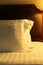 Night scene image of comfortable pillows and bed.