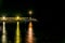 Night scene - light of small beacon on the seawall. Long exposure