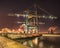 Night scene with massive crane on illuminated container terminal