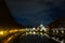 Night scene of Rome, Tevere river with basilica in background