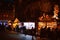 Night scene with row of market stalls chalets with multiple toys for sale in Place de la Cathedrale Notre-Dame with