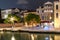 Night scene in Venice, Italy with illuminated old buildings and reflections in canal water