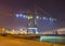 Night scene with view on with illuminated container terminal and massive crane