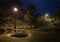 Night scenery of bench, picnic table and street light in park
