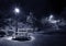 Night scenery of bench, picnic table and street light in park